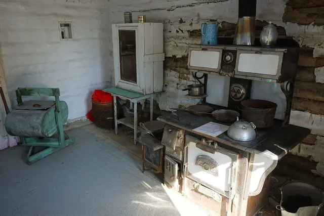 Delorme log cabin interior with wood stove